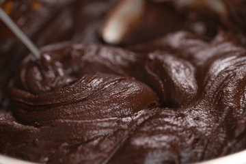 mixing cream into melted chocolate