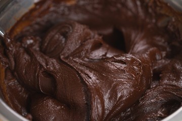 mixing cream into melted chocolate