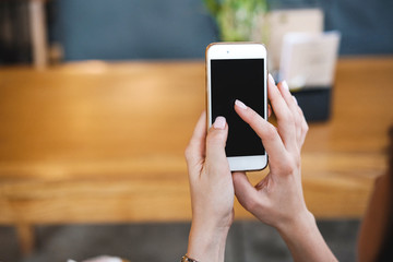 The phone in the hands of the girl. Empty Phone screen and search for applications or information on the Internet. Template.