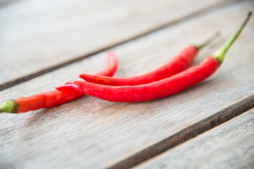Red chilli on wood table.