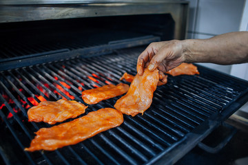 chef prepare meat on the grill