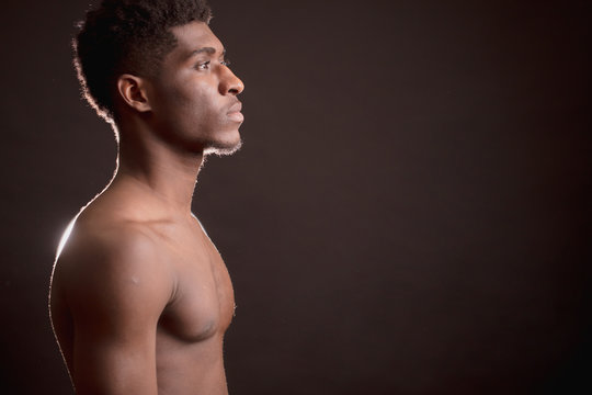 nprofile of muscular Afro swimmer isolated on the back background. healthy body