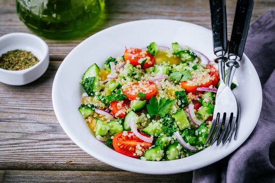 Quinoa Tabbouleh salad bowl with cucumbers, tomatoes, red onions and parsley