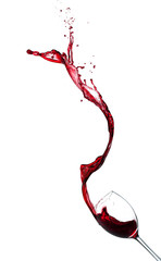Red wine splashing from glass on white background