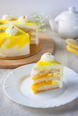 Lemon cake and piece of lemon on black background
