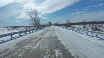Winter landscape with road and trees.