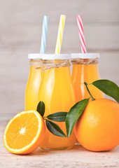 Glass bottles of raw organic fresh orange juice