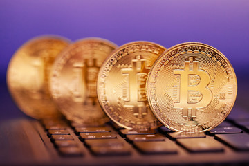four golden bitcoins on the keyboard