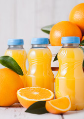 Plastic bottles of raw organic fresh orange juice