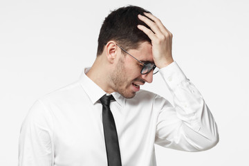 Disappointed stressed out office manager making facepalm gesture with hand. Business man face palm concept