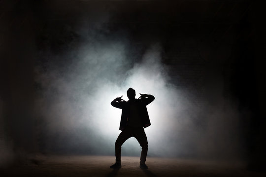 Young Rapper Dancing Isolated On Black Background