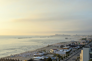 Beach of Black Sea from Mamaia, Romania with golden sands, sun umbrellas, sunbeds, blue clear...