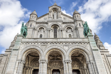 Fototapeta na wymiar Facade of The Basilica of the Sacred Heart of Paris is a Roman Catholic church and minor basilica, dedicated to the Sacred Heart of Jesus,
