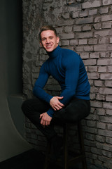 young man sitting and smiling