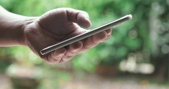 Close up the hand using smartphone touching display screen , 4K Dci resolution