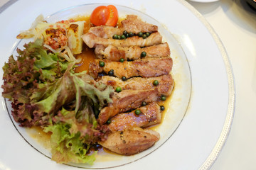 Grilled pork steak and spicy sauce on white dish