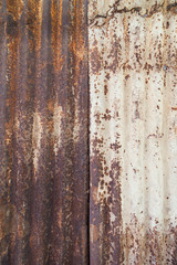 Close-up of a rusty and corrugated iron metal construction site wall texture background.