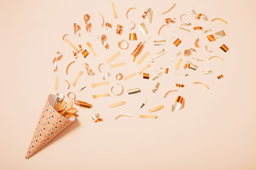 birthday hat with confetti on paper background