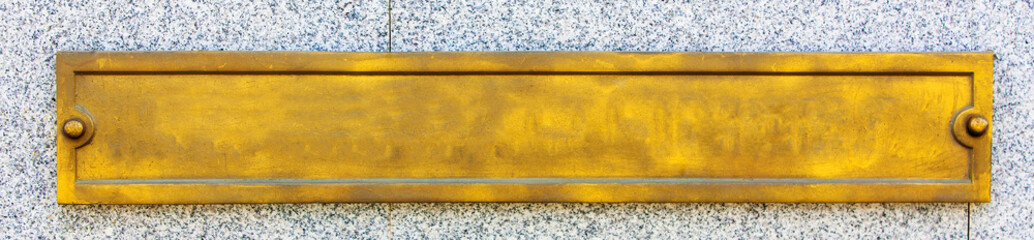 gold metal sign on the white marble