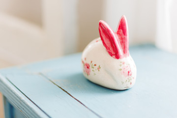 Hare porcelain figure with bright red hand painted ears and roses. Shabby chic style. Cute accessory for girlish bedroom interior.