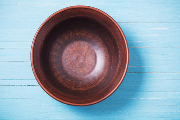 wooden dishware on blue wooden background