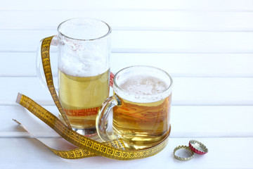 not healthy way of life/ big and small glasses of frothy drink wrapped flexible rudder and pair of lids