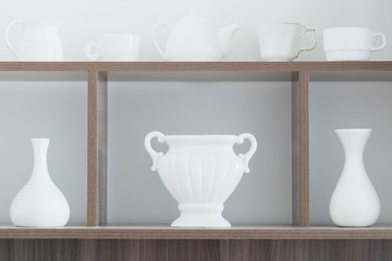 white vases on wooden shelf