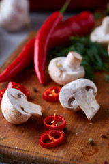 Vegetables on cutting board, plate with salt over white textured background, close-up, selective focus.
