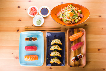 Japanese food combination, sushi nigiri, gyoza and crab salad