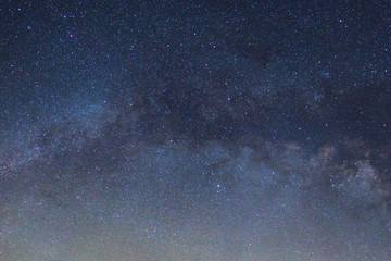 Starry night sky, Milky way galaxy with stars and space dust in the universe, Long exposure photograph, with grain.