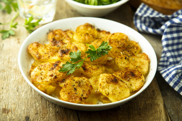 Homemade potato gratin with cheese and herbs