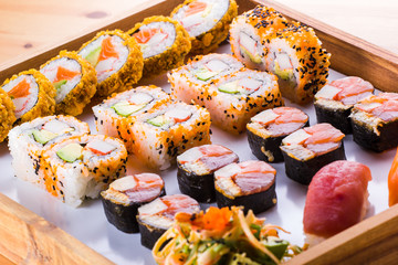 Sushi Set nigiri and sushi rolls and on wooden serving board