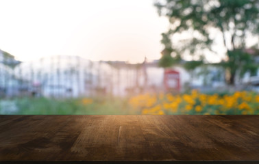 Naklejka na ściany i meble image of wooden table in front of abstract blurred background of outdoor garden lights. can be used for display or montage your products.Mock up for display of product