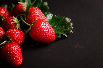 Fresh red strawberries on a black background