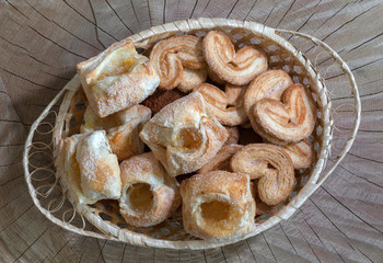 Cookies with jam in a basket on a wooden background. Top view.