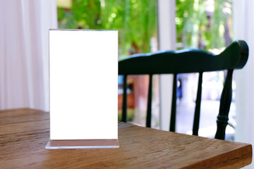 Mock up Menu frame standing on wood table in Bar restaurant cafe. space for text