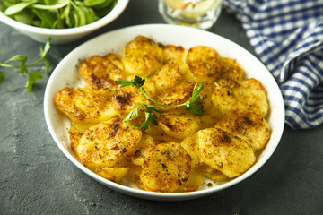 Homemade potato gratin with cheese and herbs