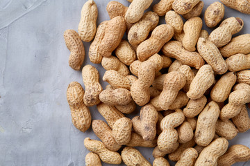 Seamless pattern shelled peanuts isolated on white background, top view, close-up, selective focus