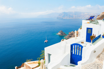 White building with blue doors on Santorini island, Greece