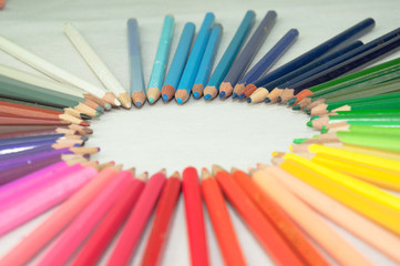 wooden colored pencils on white texture