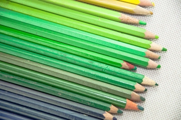 wooden colored pencils on white texture