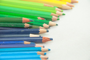 wooden colored pencils on white texture