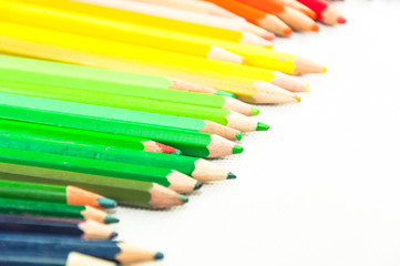 wooden colored pencils on white texture