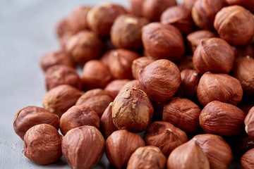 Raw hazelnut on heap isolated on white background, selective focus, shallow depth of field