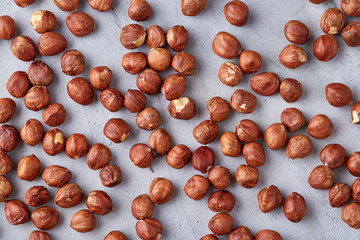 Raw hazelnut on heap isolated on white background, selective focus, shallow depth of field