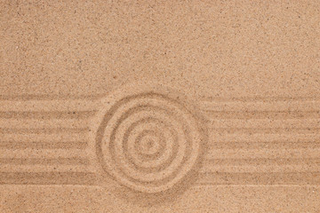 Fototapeta na wymiar Concentric circle and lines on the sand. Texture of sand.