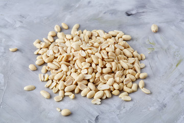 Pile of peelled peanuts isolated on white textured background, background, top view, close-up, selective focus