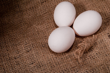 white chicken eggs on burlap
