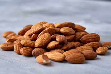 Seamless pattern with almond on the gray background, flat lay, close-up.