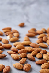 Seamless pattern with almond on the gray background, flat lay, close-up.